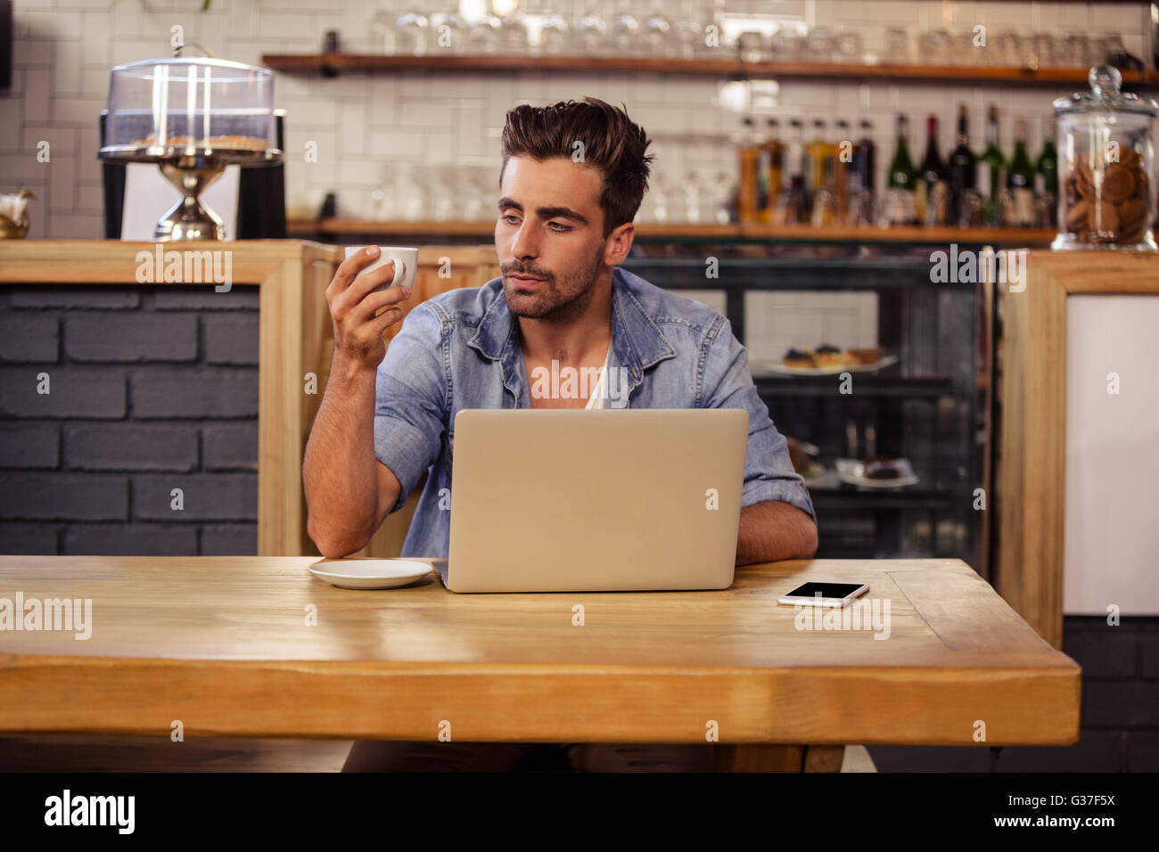 Portrait of hipster man sipping coffee Stock Photo