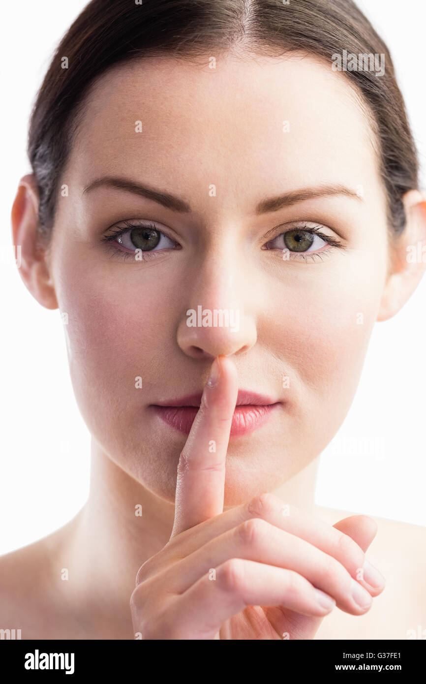 Focus on woman with her finger on mouth Stock Photo