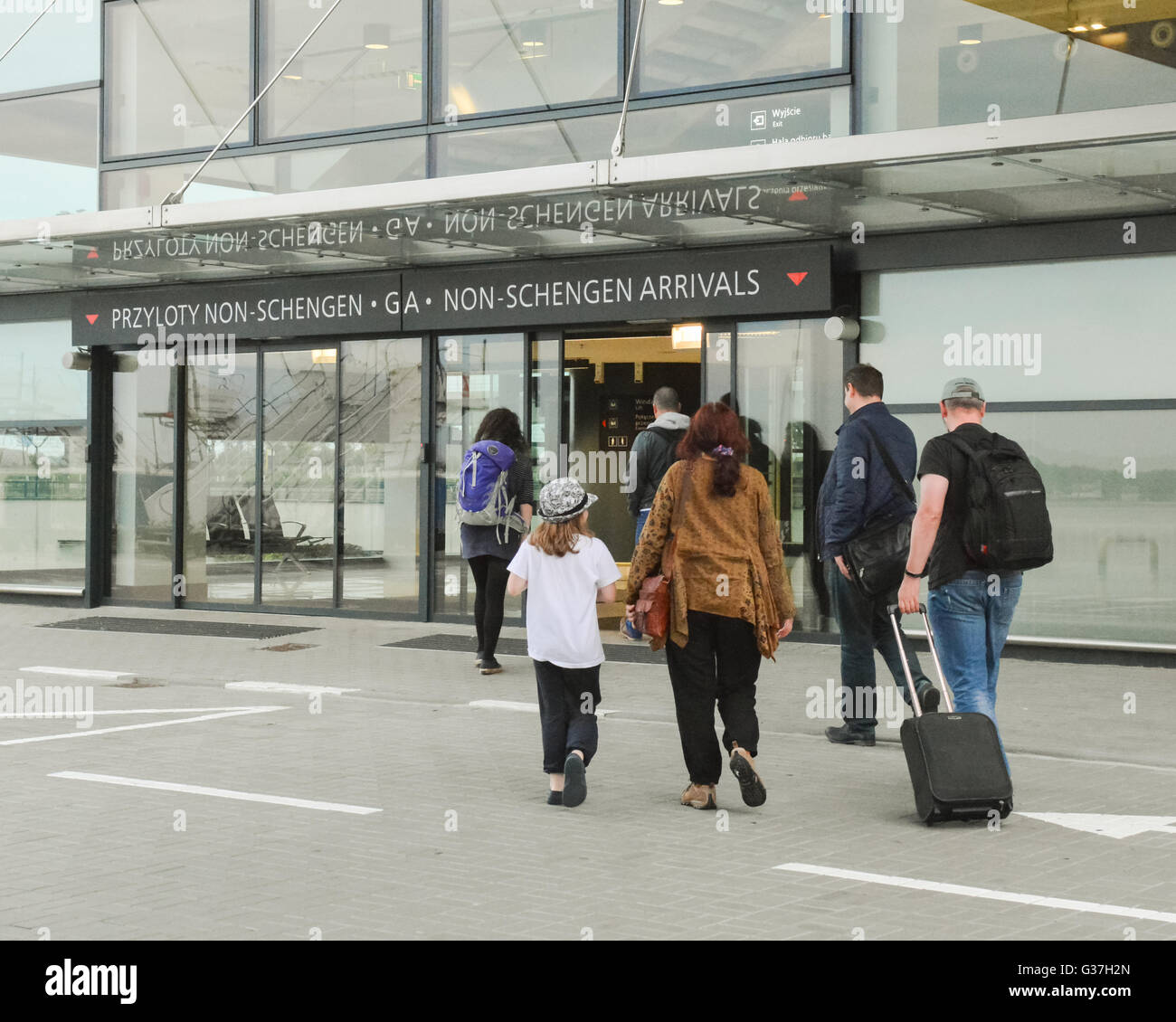 Passengers from flight from the uk entering Gdansk airport in Poland through the Non-Schengen Arrivals door Stock Photo