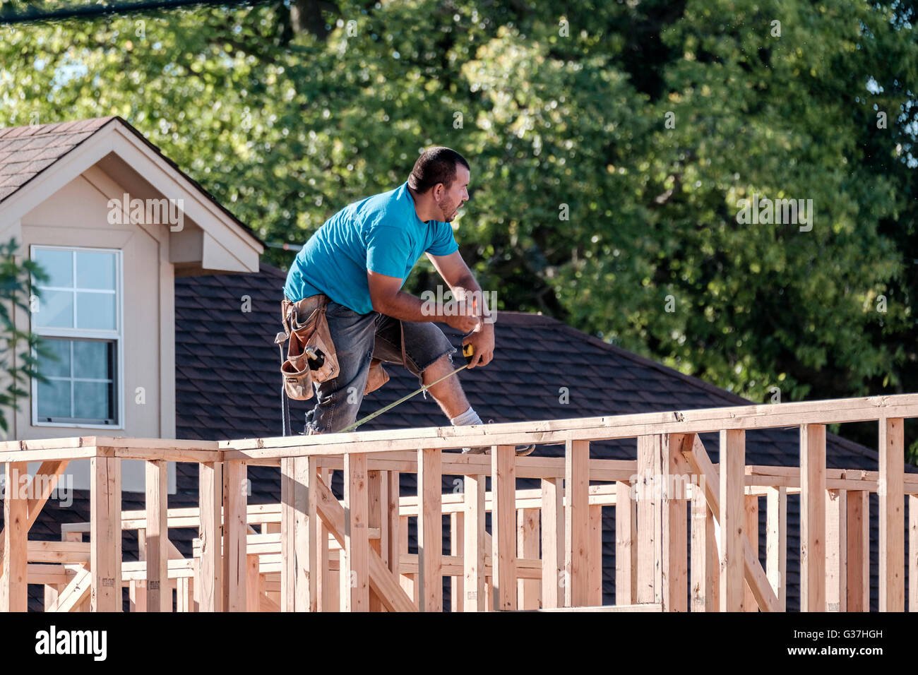 A Hispanic man working on framing a new house in Oklahoma City, Oklahoma, USA. Stock Photo