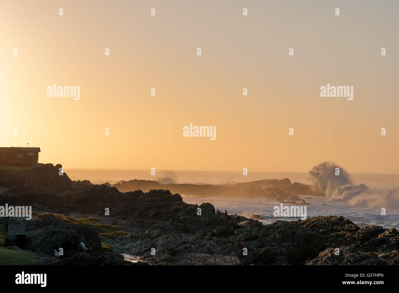 The sun is rising at Storms River Mouth Rest Camp Stock Photo