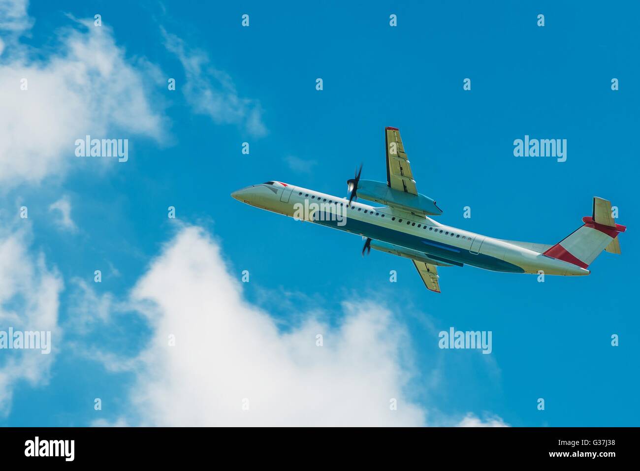 Turboprop Jet Airplane Traveling. Airplane on the Cloudy Blue Sky Stock ...