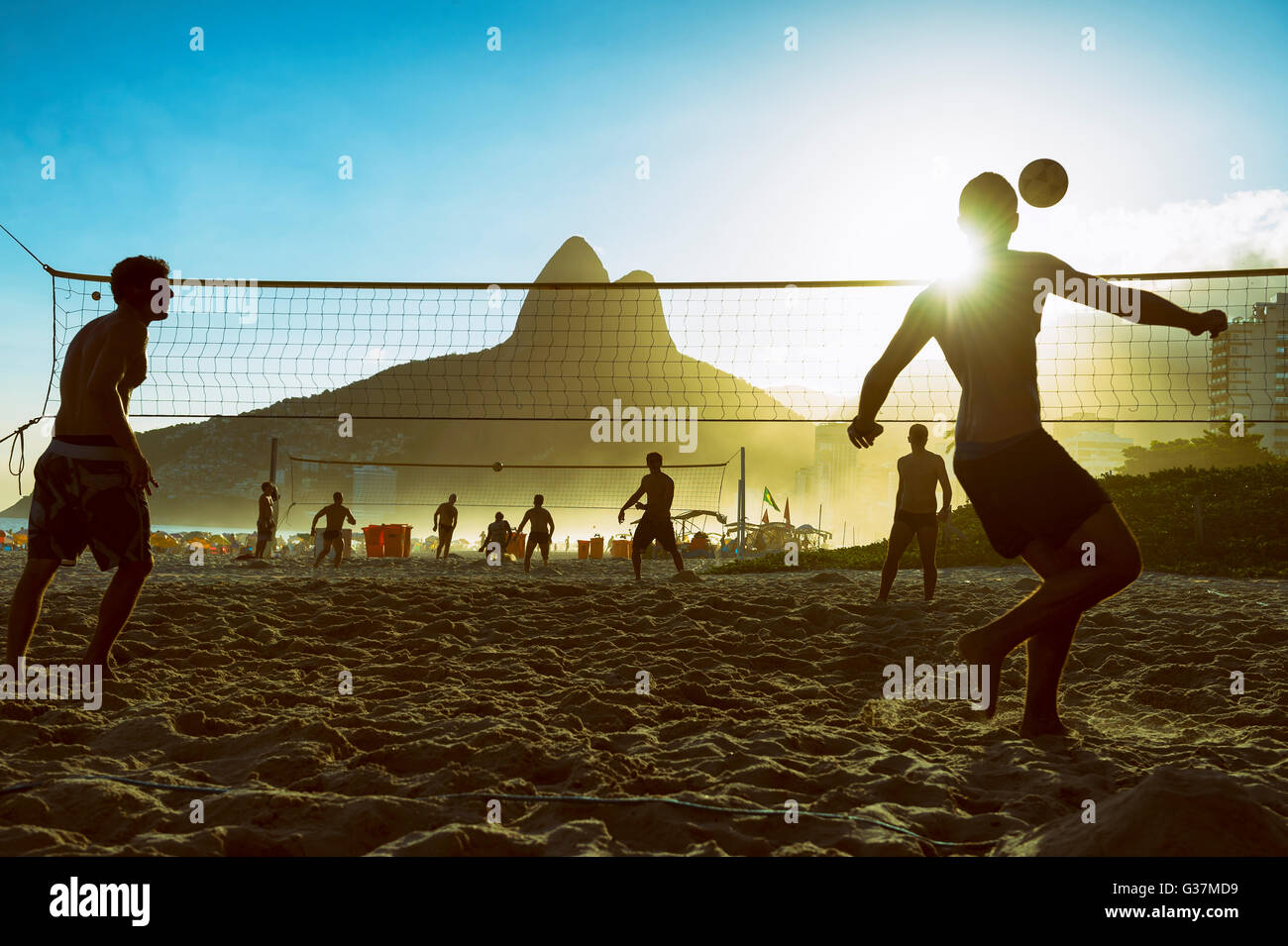 RIO DE JANEIRO - MARCH 27, 2016: Brazilians play futevôlei (footvolley, a sport combining football/soccer and volleyball). Stock Photo