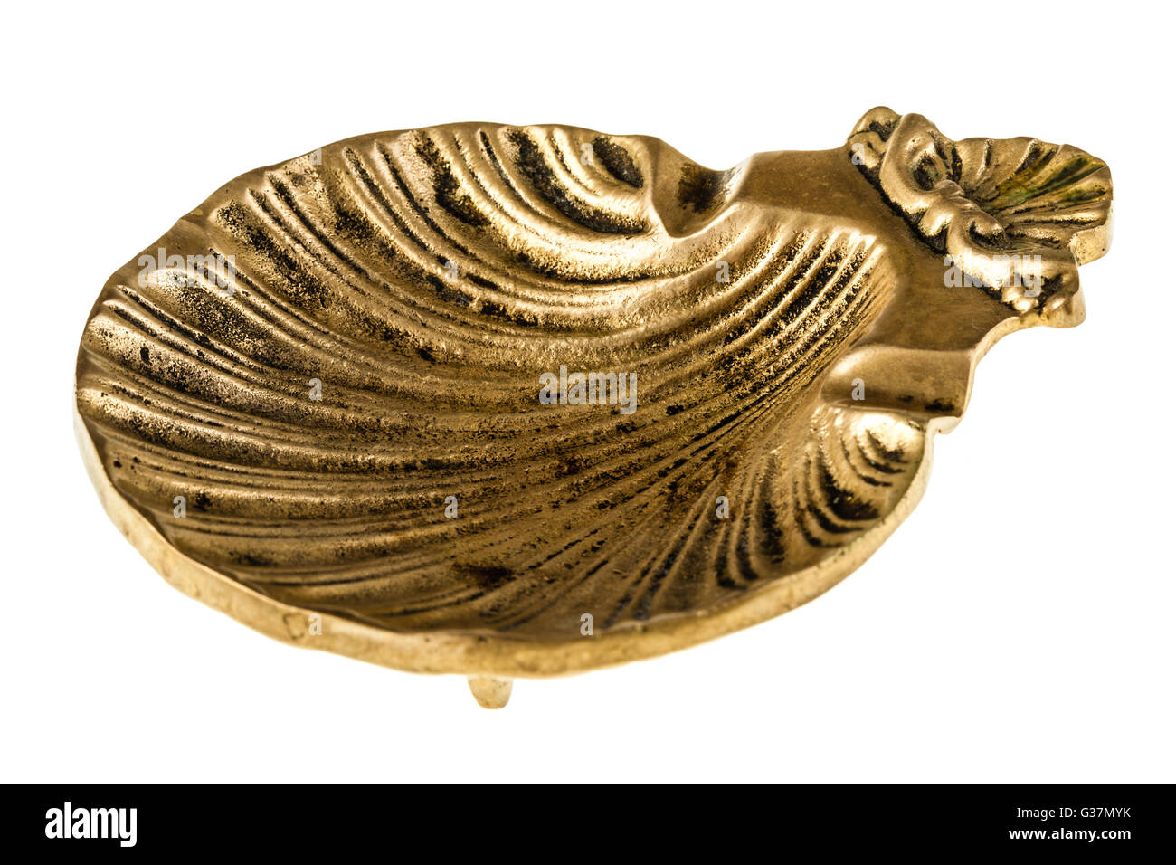 a shell shaped bronze ashtray isolated over a white background Stock Photo