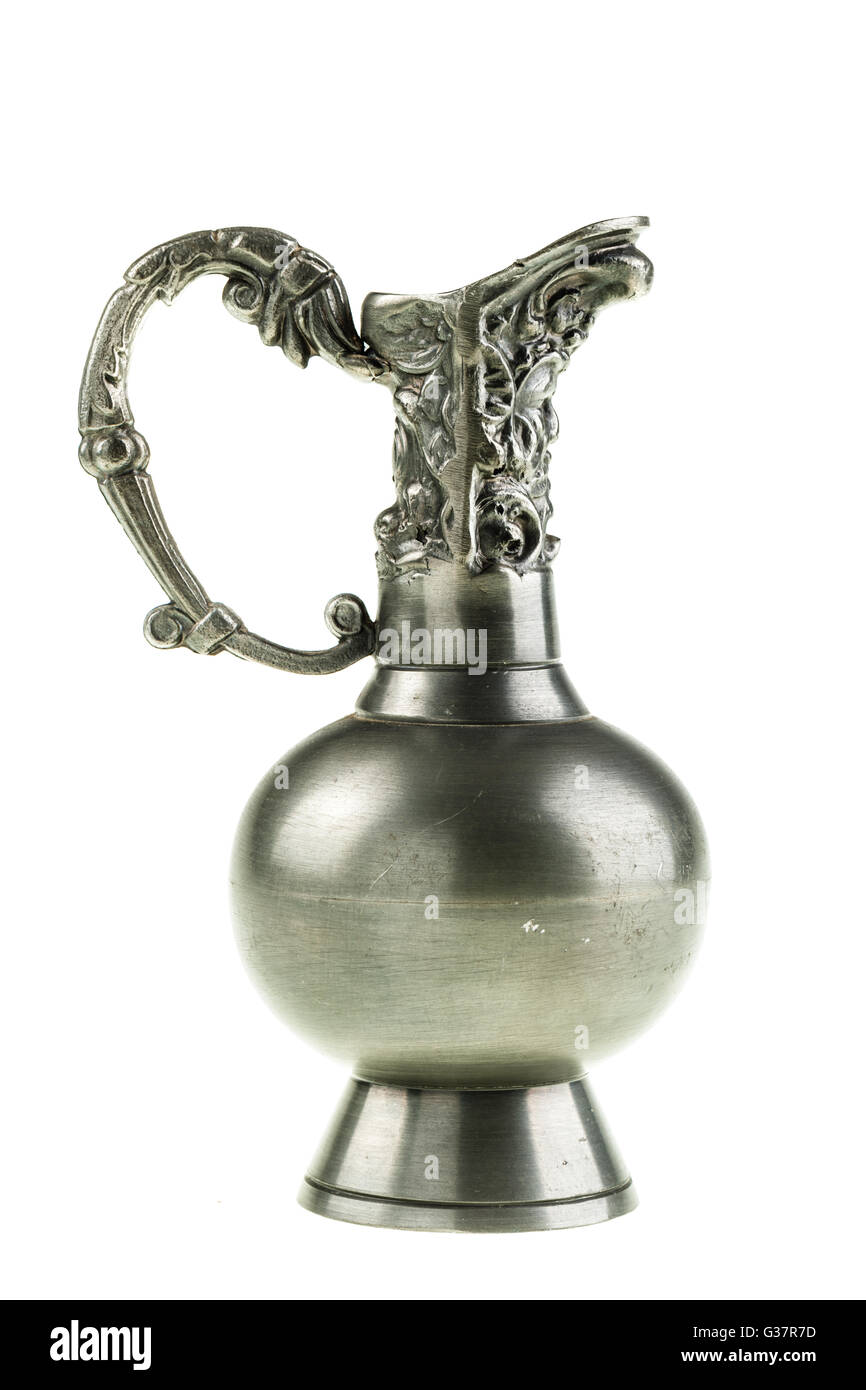 an ancient pewter pitcher isolated over a white background Stock Photo