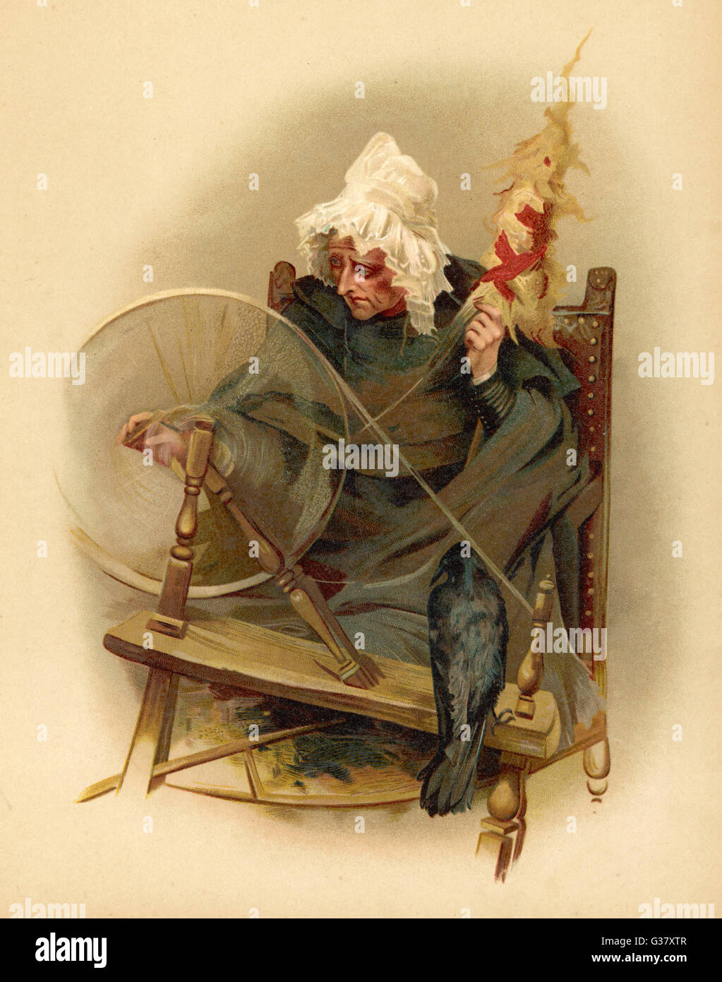 Witch and tame crow at her spinning wheel. Stock Photo
