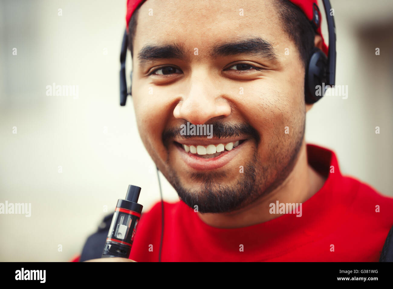 portrait-of-young-black-guy-using-modern-e-cig-vaporizer-device-for-G381WG.jpg