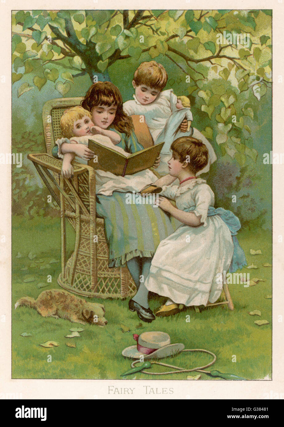 Four children in the garden  read a fairy story         Date: circa 1880 Stock Photo