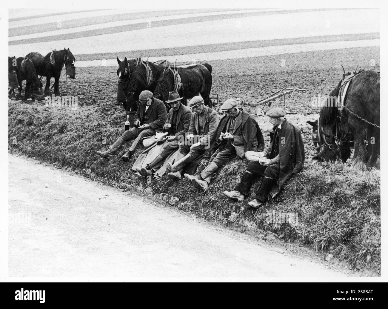 Ploughman's Lunch; farmworkers  break at mid-day on the Wiltshire Downs       Date: 1937 Stock Photo