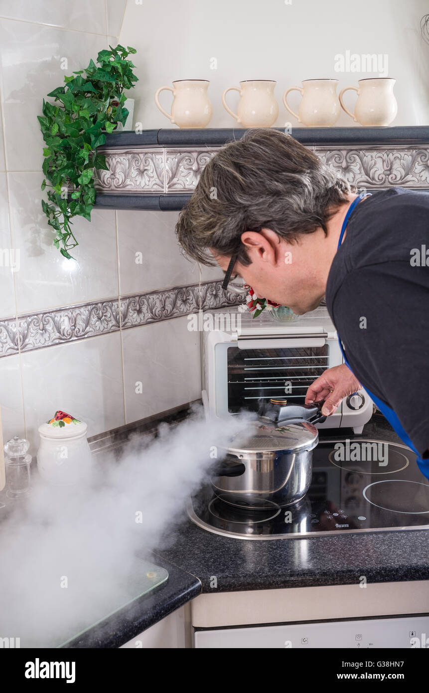 Releasing steam from a pressure cooker Stock Photo Alamy