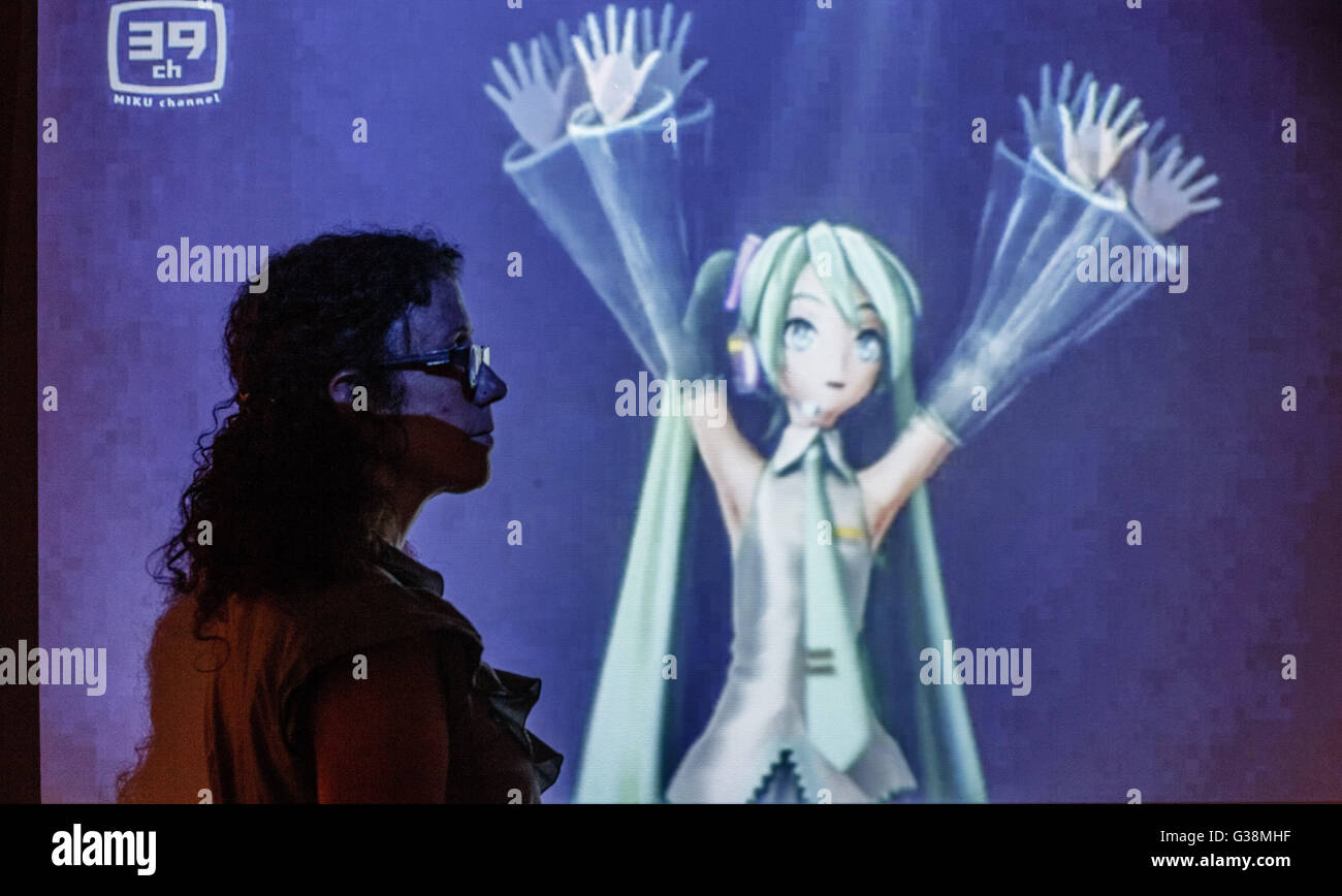 A visitor stands in front of a projection of virtual singer Miku Hatsune at the exhibition 'Hokusai Manga, Japanese pop culture since 1680' at the museum for arts and industry in Hamburg, 9 June 2016. The exhibition will stay in Hamburg until 11 September 2016. Photo: Markus Scholz/dpa Stock Photo