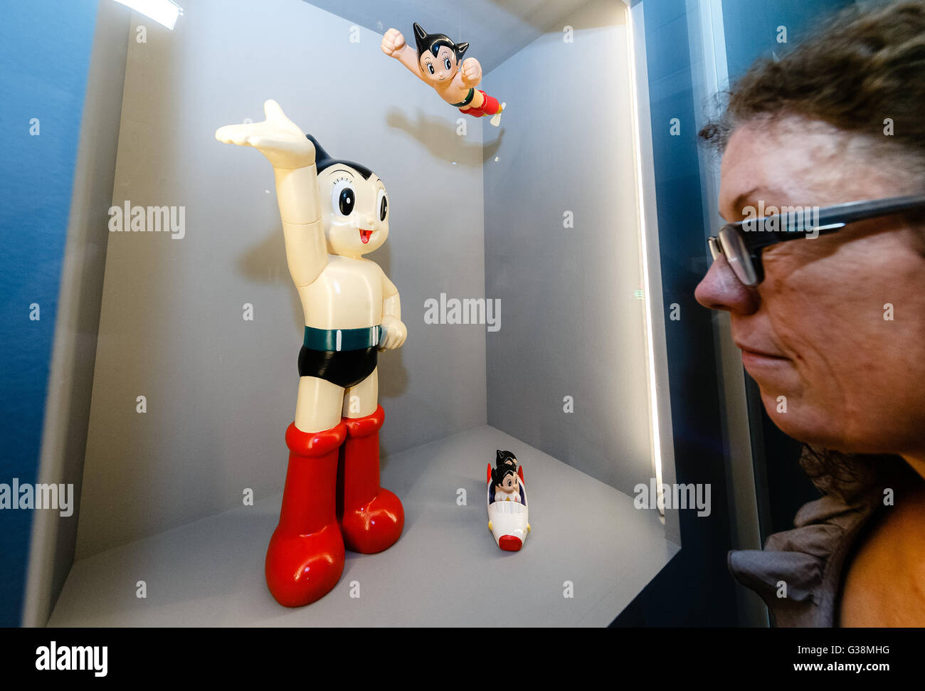 A visitor looks at the comic figure 'Astro Boy' in a cabinet  at the exhibition 'Hokusai Manga, Japanese pop culture since 1680' at the museum for arts and industry in Hamburg, 9 June 2016. The exhibition will stay in Hamburg until 11 September 2016. Photo: Markus Scholz/dpa Stock Photo