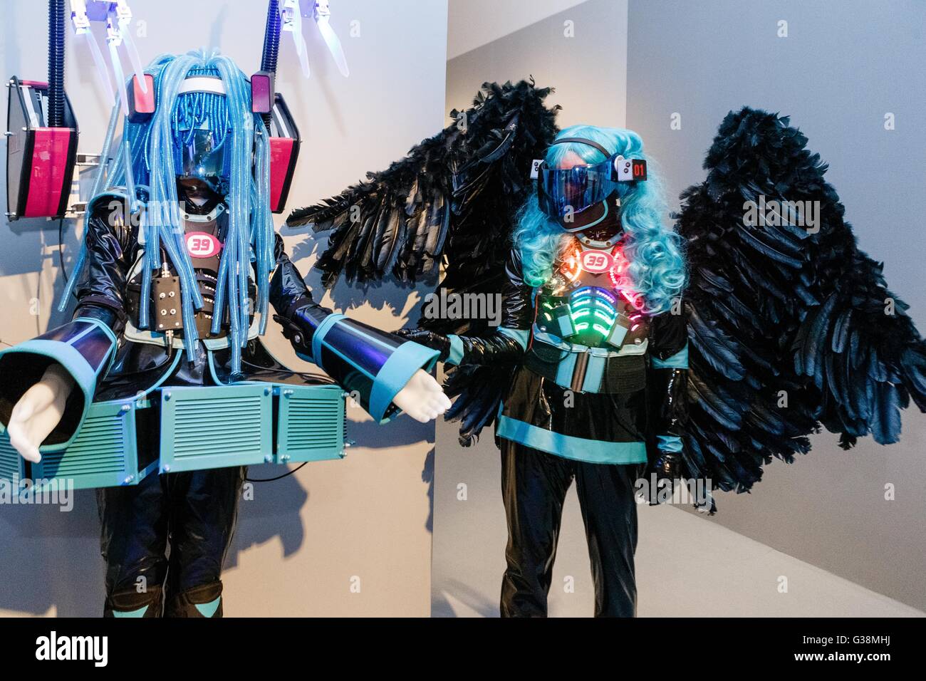 Costume player Rudolf Arnold poses next to the costume of virtual hit singer, Miku Hatsune, at the exhibition 'Hokusai Manga, Japanese pop culture since 1680' at the museum for arts and industry in Hamburg, 9 June 2016. The exhibition will stay in Hamburg until 11 September 2016. Photo: Markus Scholz/dpa Stock Photo