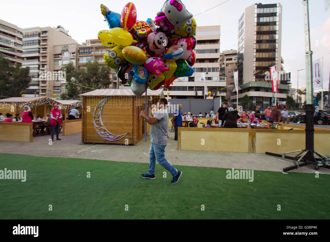 Beirut, Lebanon. 9th June, 2016. A man carries balloons as  Devout Muslim families prepare to end their daily Ramadan fast at sunset for the evening meal known as 'Iftar'  at the purposely built Ramadan Village in Beirut Credit:  amer ghazzal/Alamy Live News Stock Photo