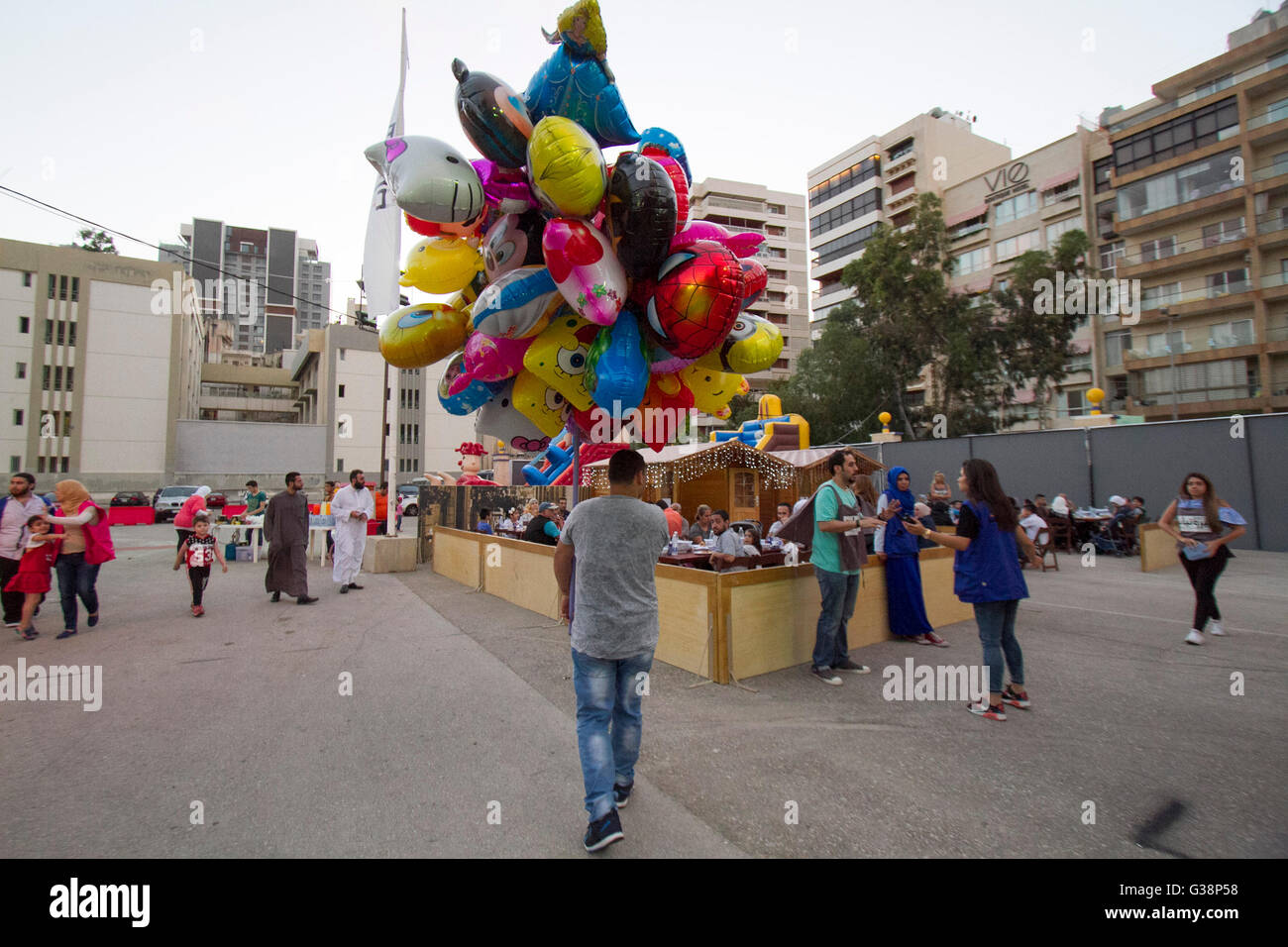 Beirut, Lebanon. 9th June, 2016. A man carries balloons as Devout Muslim families prepare to end their daily Ramadan fast at sunset for the evening meal known as 'Iftar'  at the purposely built Ramadan Village in Beirut Credit:  amer ghazzal/Alamy Live News Stock Photo