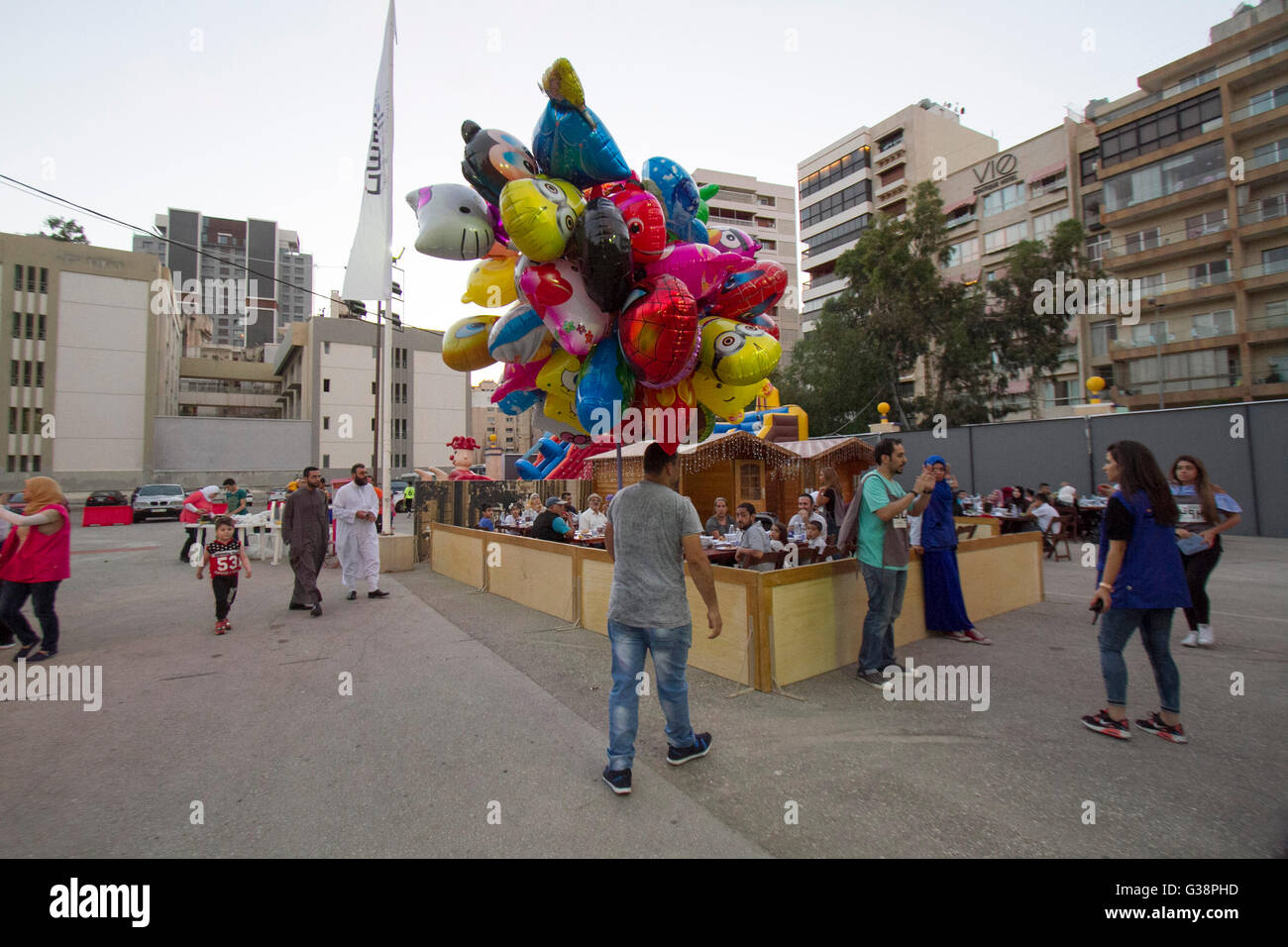 Beirut, Lebanon. 9th June, 2016. A man carries balloons as Devout Muslim families prepare to end their daily Ramadan fast at sunset for the evening meal known as 'Iftar'  at the purposely built Ramadan Village in Beirut Credit:  amer ghazzal/Alamy Live News Stock Photo
