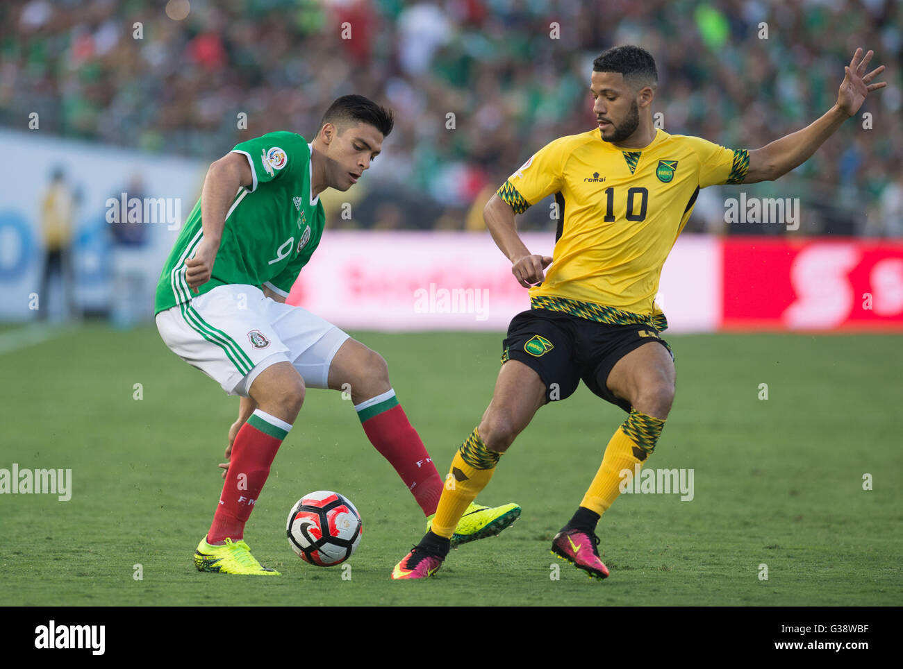 Pasadena, USA. 9th June, 2016. Mexico's Raul Jimenez (L) vies with Jamaica's Joel Mcanuff during the Copa America Centenario tournament Group C football match in Pasadena, California, the United States, on June 9, 2016. Credit:  Yang Lei/Xinhua/Alamy Live News Stock Photo