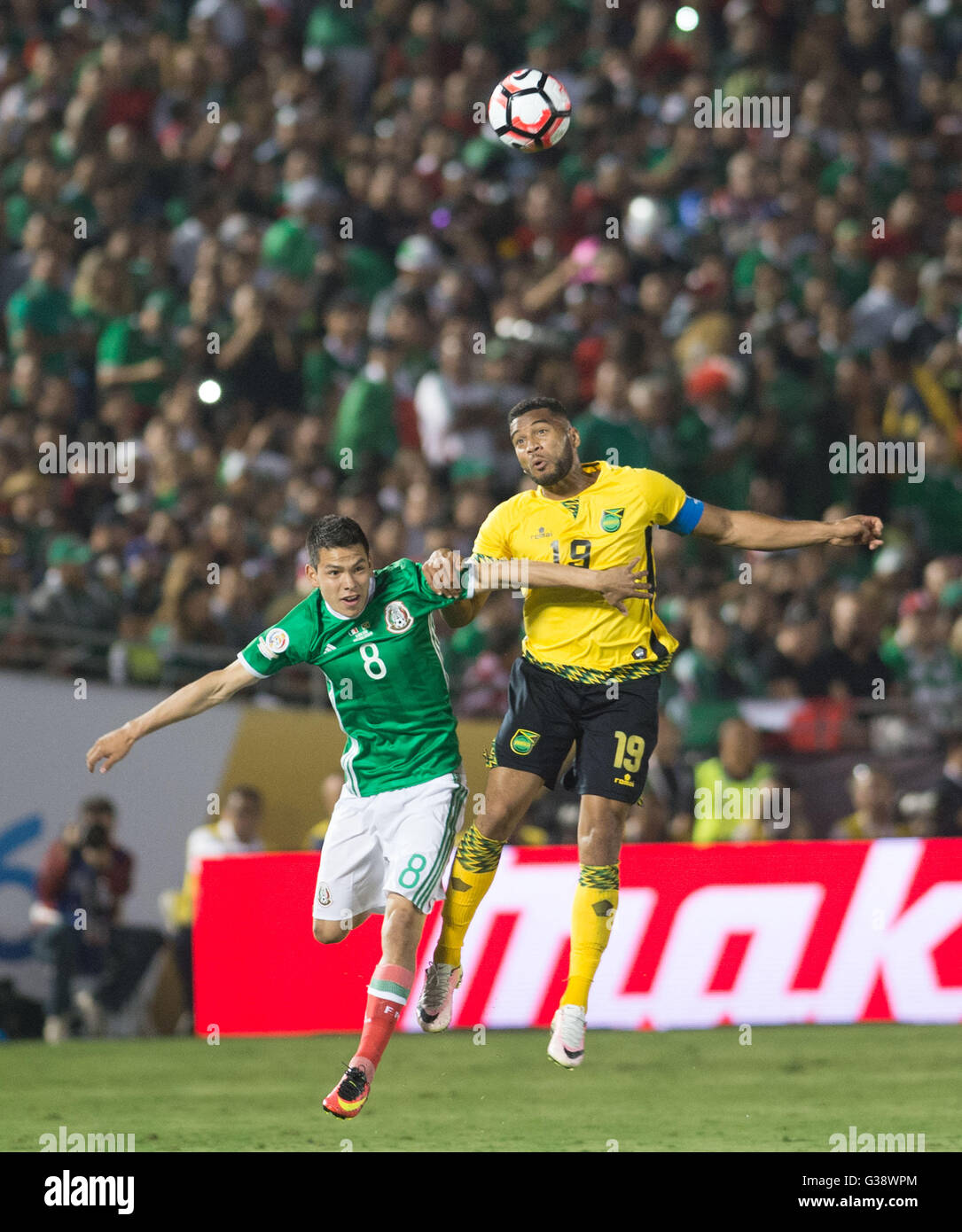 Pasadena, USA. 9th June, 2016. Mexico's Hirving Lozano (L) vies with Jamaica's Giles Barnes during the Copa America Centenario tournament Group C football match in Pasadena, California, the United States, on June 9, 2016. Credit:  Yang Lei/Xinhua/Alamy Live News Stock Photo