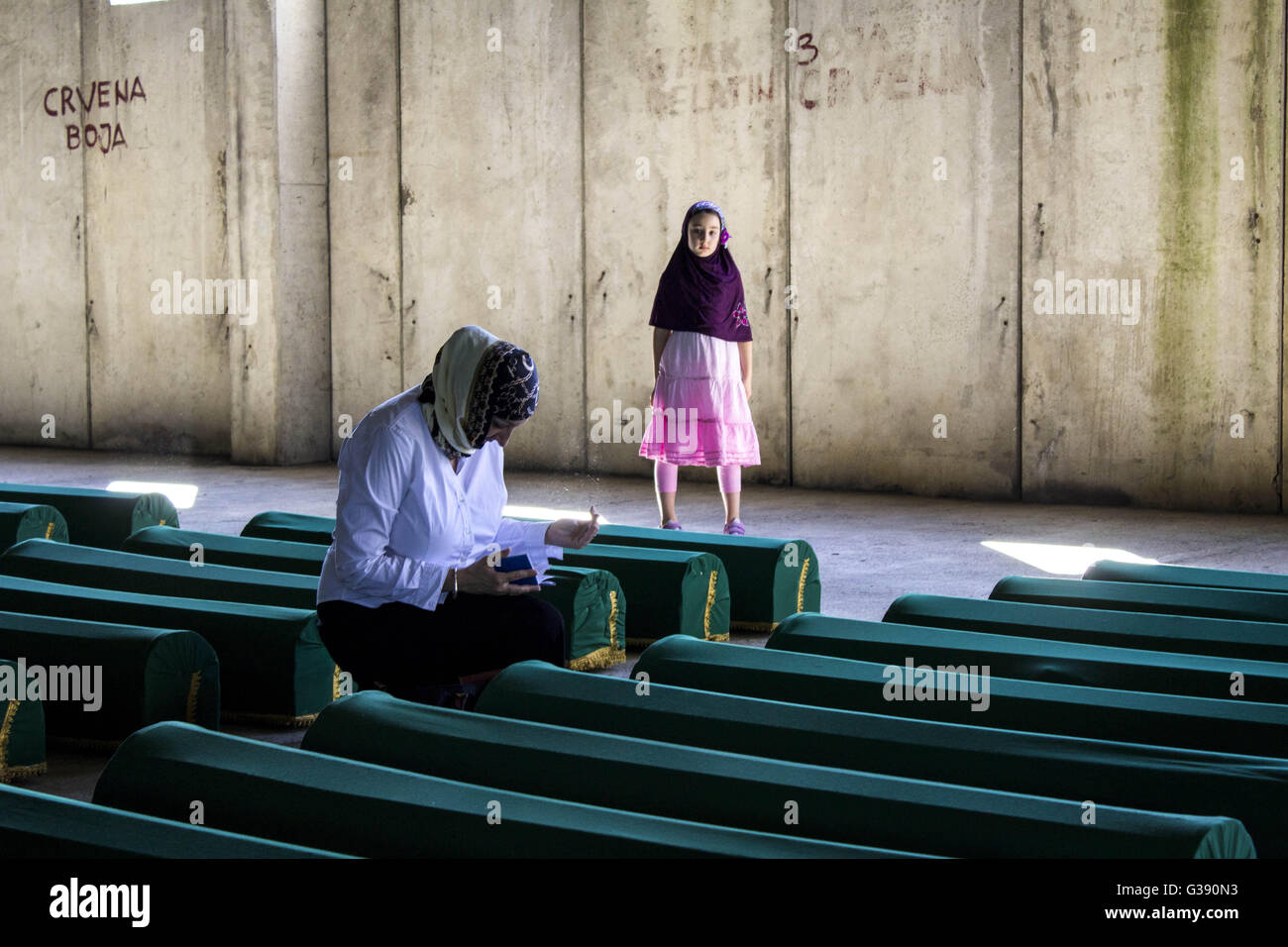 June 10, 2016 - PotoÄAri, Bosnia and Herzegovina - A file photo dated 10. July 2015. is showing women praying next to the coffins. As of now, 105 victims of Srebrenica massacre are going to be buried in Potocari during ceremonies marking the 21th anniversary of the massacre. During the war in Bosnia from 1992-95, 8,000 Muslim men and boys were executed by Bosnian Serb forces over five days and their bodies dumped in pits, then dug up and scattered in smaller pits. © Armin Durgut/ZUMA Wire/Alamy Live News Stock Photo