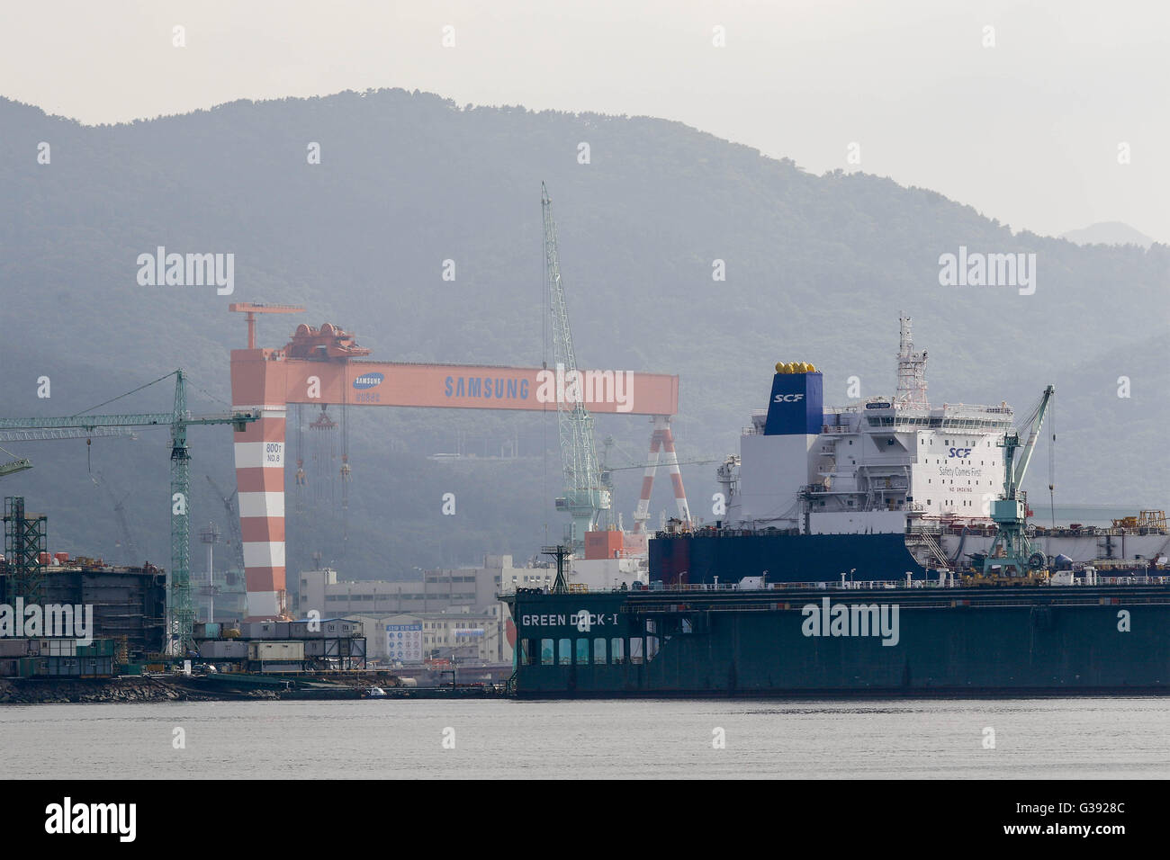 June 7, 2016 - Geoje, Gyeongnam, South Korea - Ships under construction sit moored at the Samsung Heavy Industry shipyard in Geoje, South Korea. Shipbuilding has been central to South Korea's economy since the 1970s. Ships accounted for 8.5 percent of the country's total exports through June 20 of October 2015, according to the trade ministry. After more than a decade of global dominance, South Korea's shipbuilders face an unprecedented crisis that threatens the very survival of one of the flagship industries of Asia's fourth largest economy. Major South Korean shipbuilders plan to restructure Stock Photo