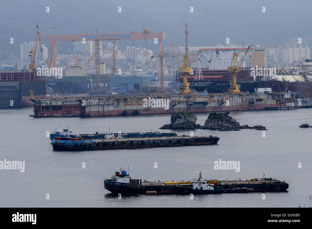 June 7, 2016 - Geoje, Gyeongnam, South Korea - Ships under construction sit moored at the DSME shipyard in Geoje, South Korea. Shipbuilding has been central to South Korea's economy since the 1970s. Ships accounted for 8.5 percent of the country's total exports through June 20 of October 2015, according to the trade ministry. After more than a decade of global dominance, South Korea's shipbuilders face an unprecedented crisis that threatens the very survival of one of the flagship industries of Asia's fourth largest economy. Major South Korean shipbuilders plan to restructure their operations  Stock Photo