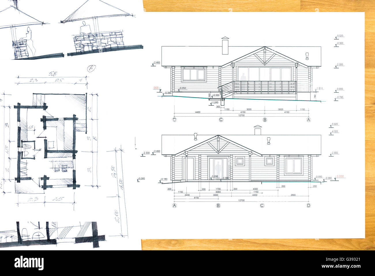 designer's hand drawing with house plan blueprints Stock Photo