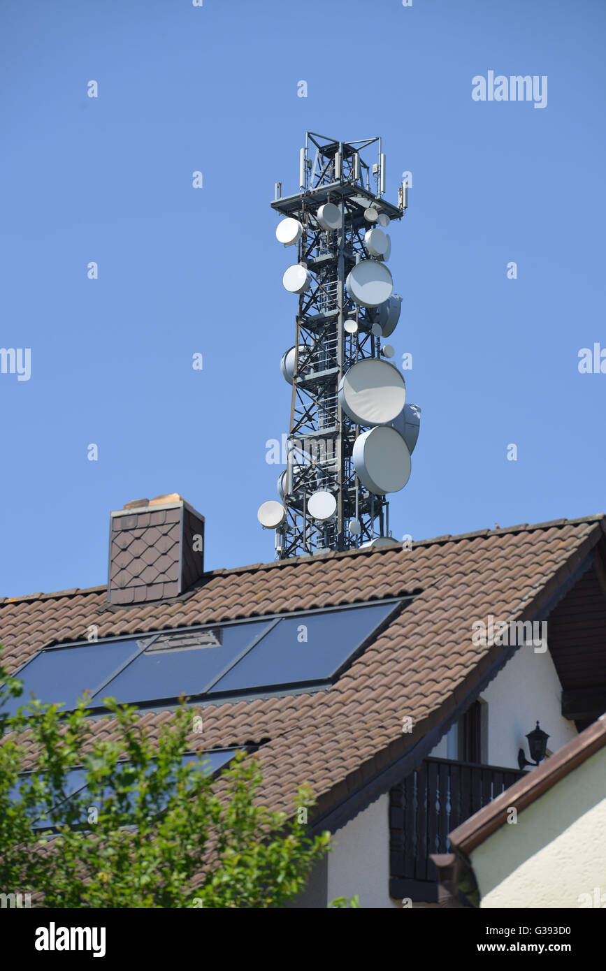 Solar panels on roof, cell tower Stock Photo