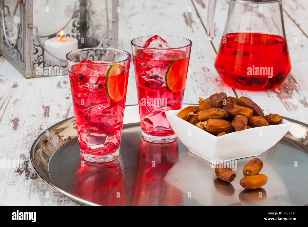 Cold refreshing syrup drink, sweet dates and fruit for iftar break fast during fasting month of Ramadan. Stock Photo