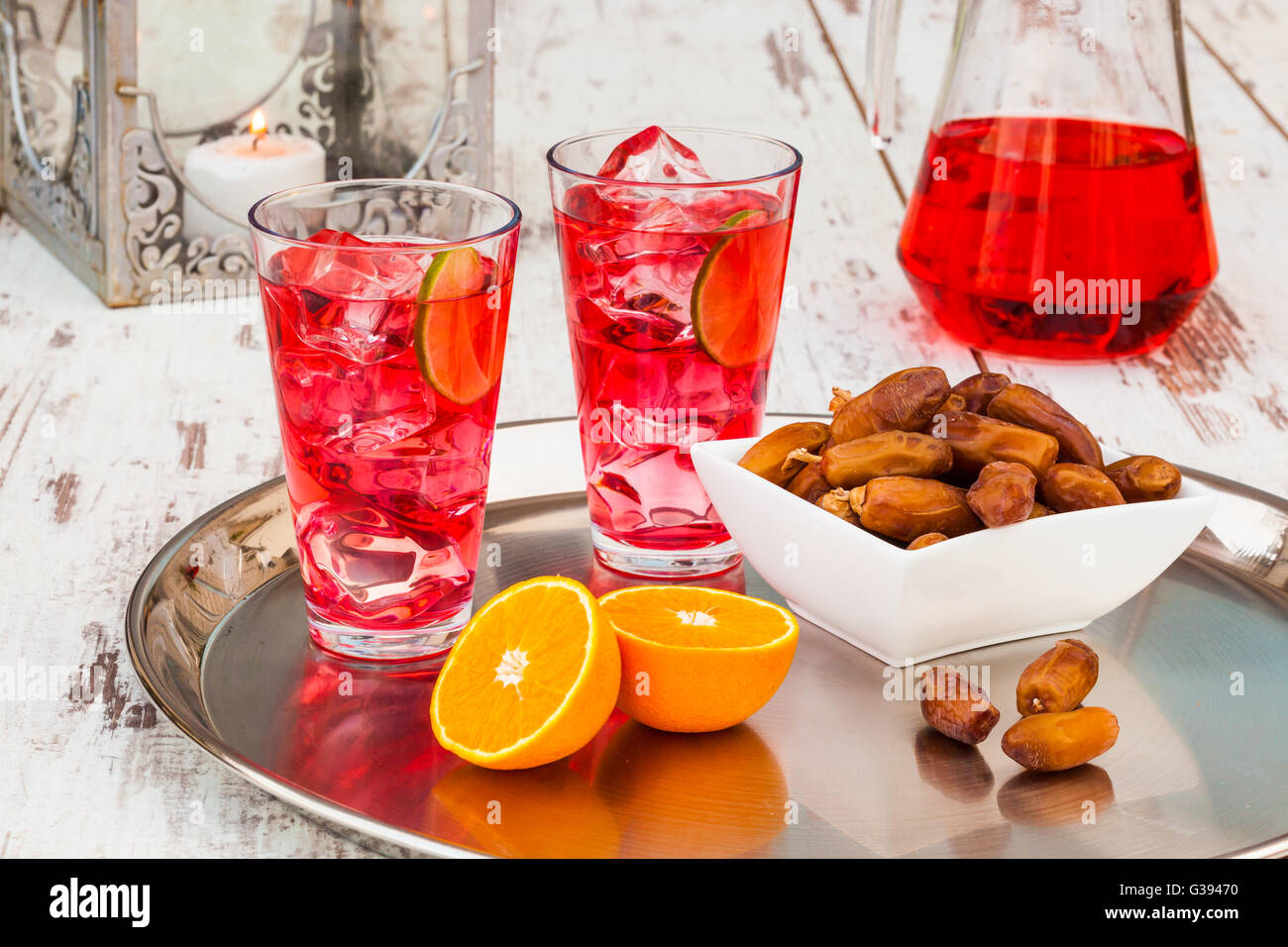 Cold refreshing syrup drink, sweet dates and fruit for iftar break fast during fasting month of Ramadan. Stock Photo