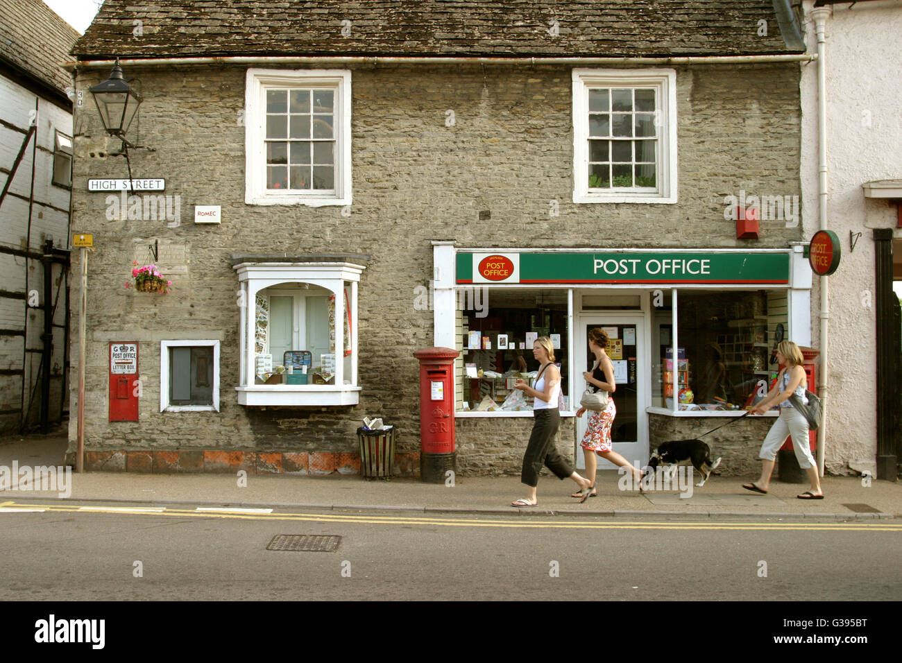 The Cotswolds. Post office with three post boxes on the High Street at