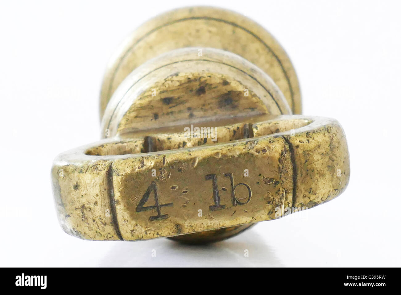 4 lb old fashioned Imperial brass weight which was used on traditional scales, pre metric. Stock Photo