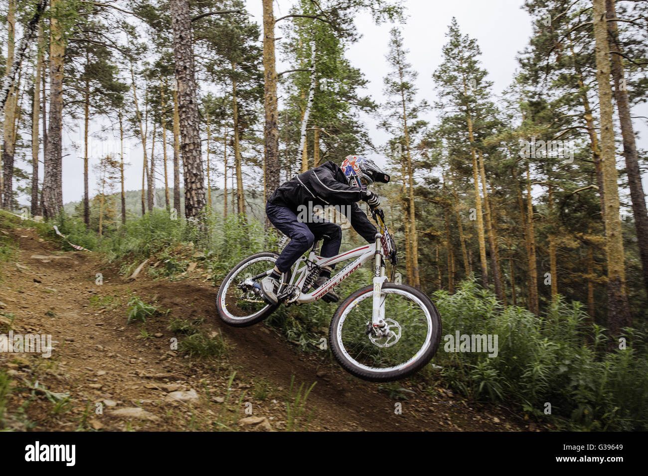 rider on a bicycle coming down mountain at high speed during Cup 'Ryder' downhill Stock Photo