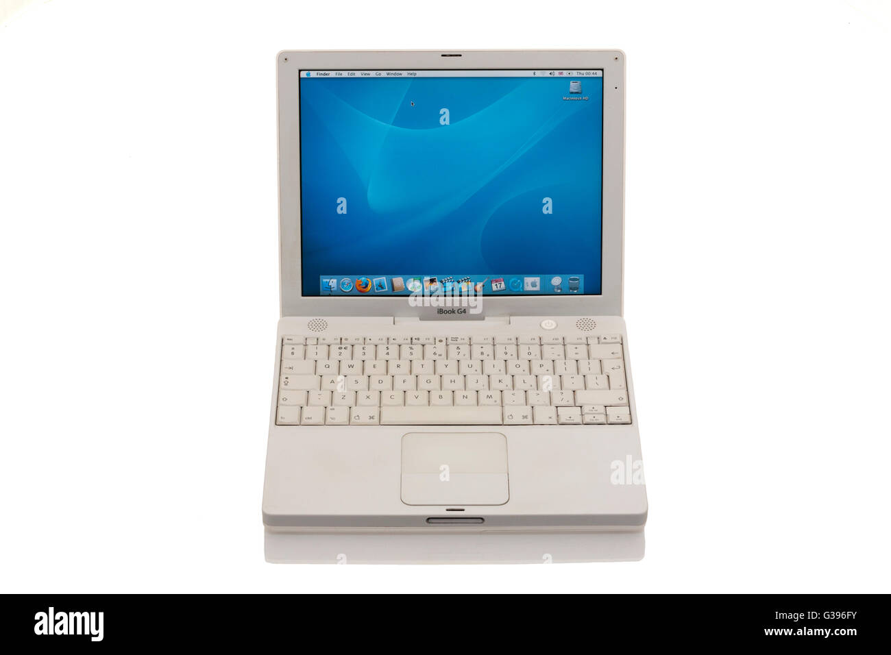 Apple iBook G4 laptop / lap top computer with scrolling TrackPad / trackpad / track pad, home screen & keyboard. Stock Photo