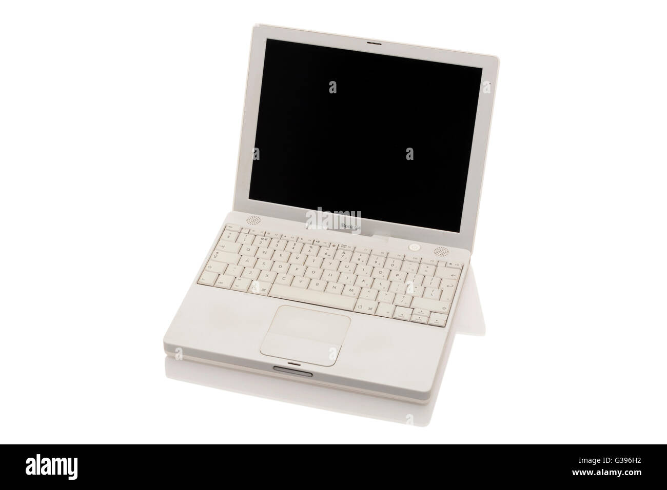 Apple iBook G4 laptop / lap top computer with scrolling TrackPad / trackpad / track pad, blank screen & keyboard. Stock Photo