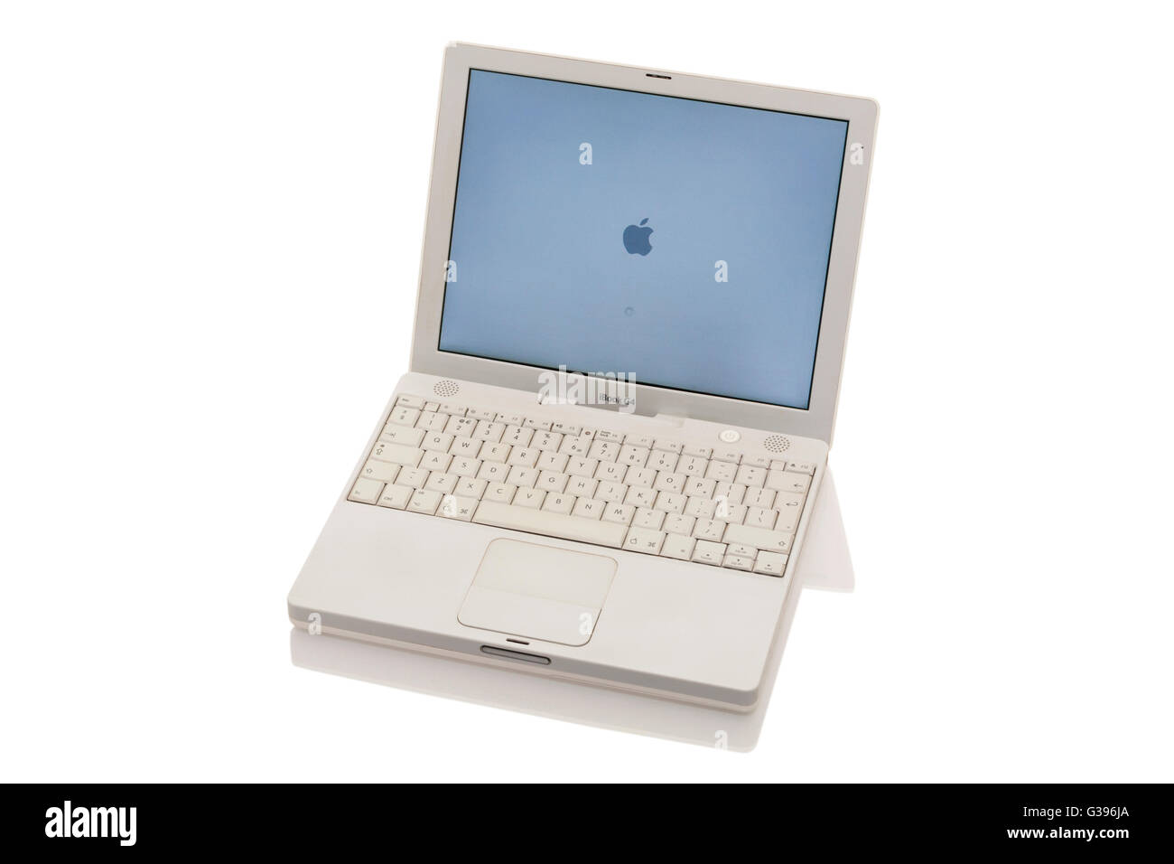 Apple iBook G4 laptop / lap top computer with scrolling TrackPad / trackpad / track pad, start / starting up screen & keyboard. Stock Photo