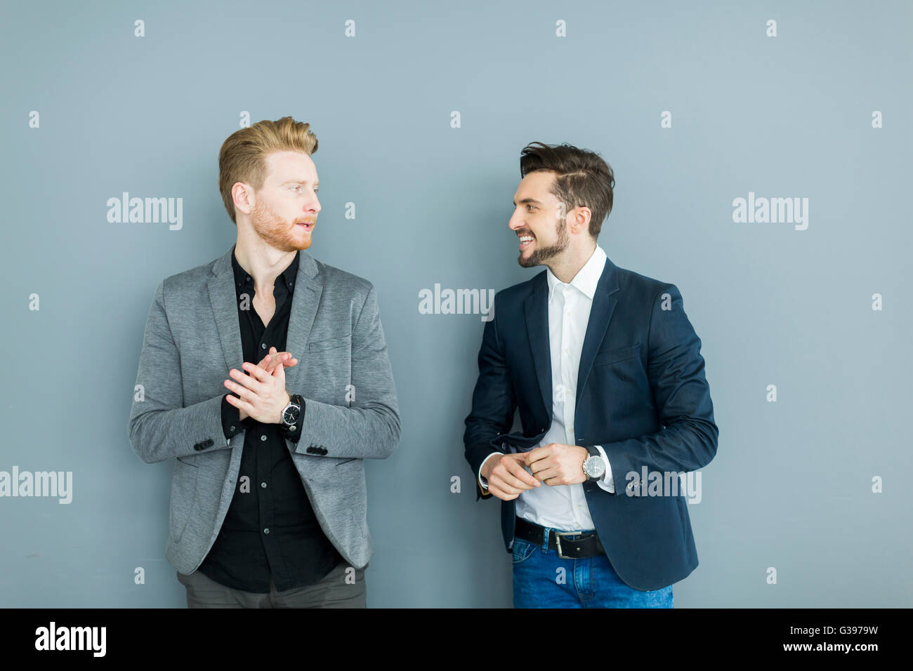 Two young businessmen talking in the office Stock Photo - Alamy