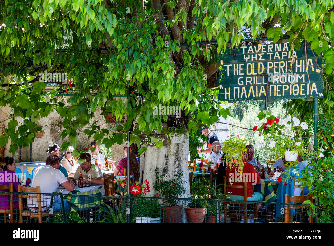 Tourists Eating At A Taverna In The Village Of Old Perithea, Corfu Island, Greece Stock Photo