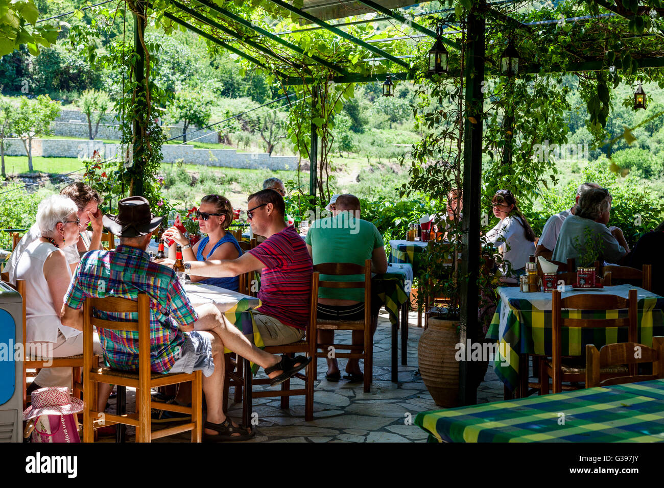 Tourists Eating At A Taverna In The Village Of Old Perithea, Corfu Island, Greece Stock Photo