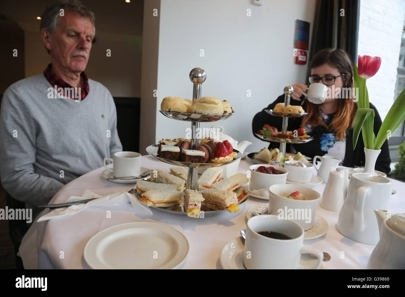 Surrey England Frensham Pond Hotel Father And Daughter In Restaurant Having High Tea Stock Photo