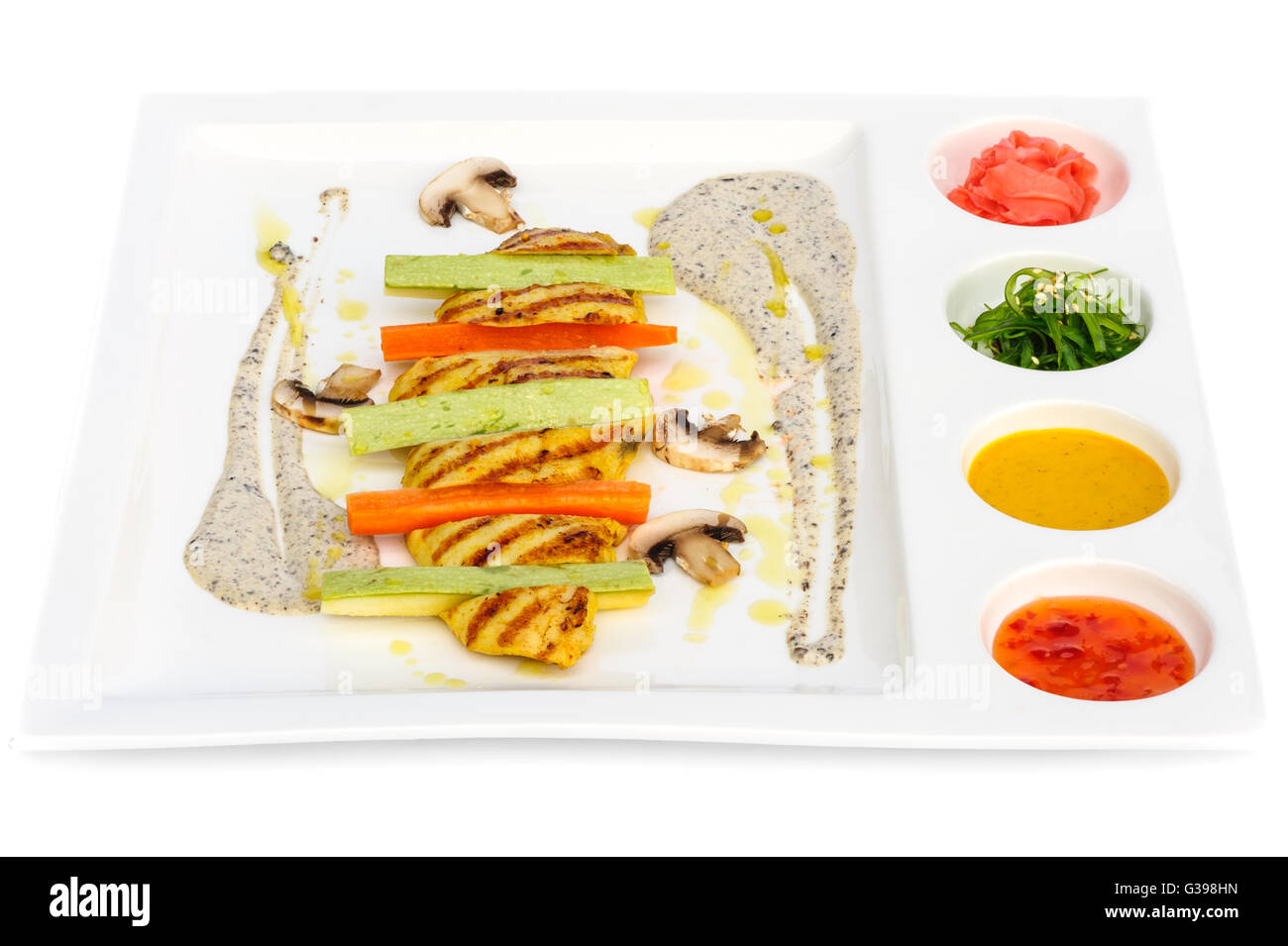 Grilled chicken fillet and squash with sauces Stock Photo
