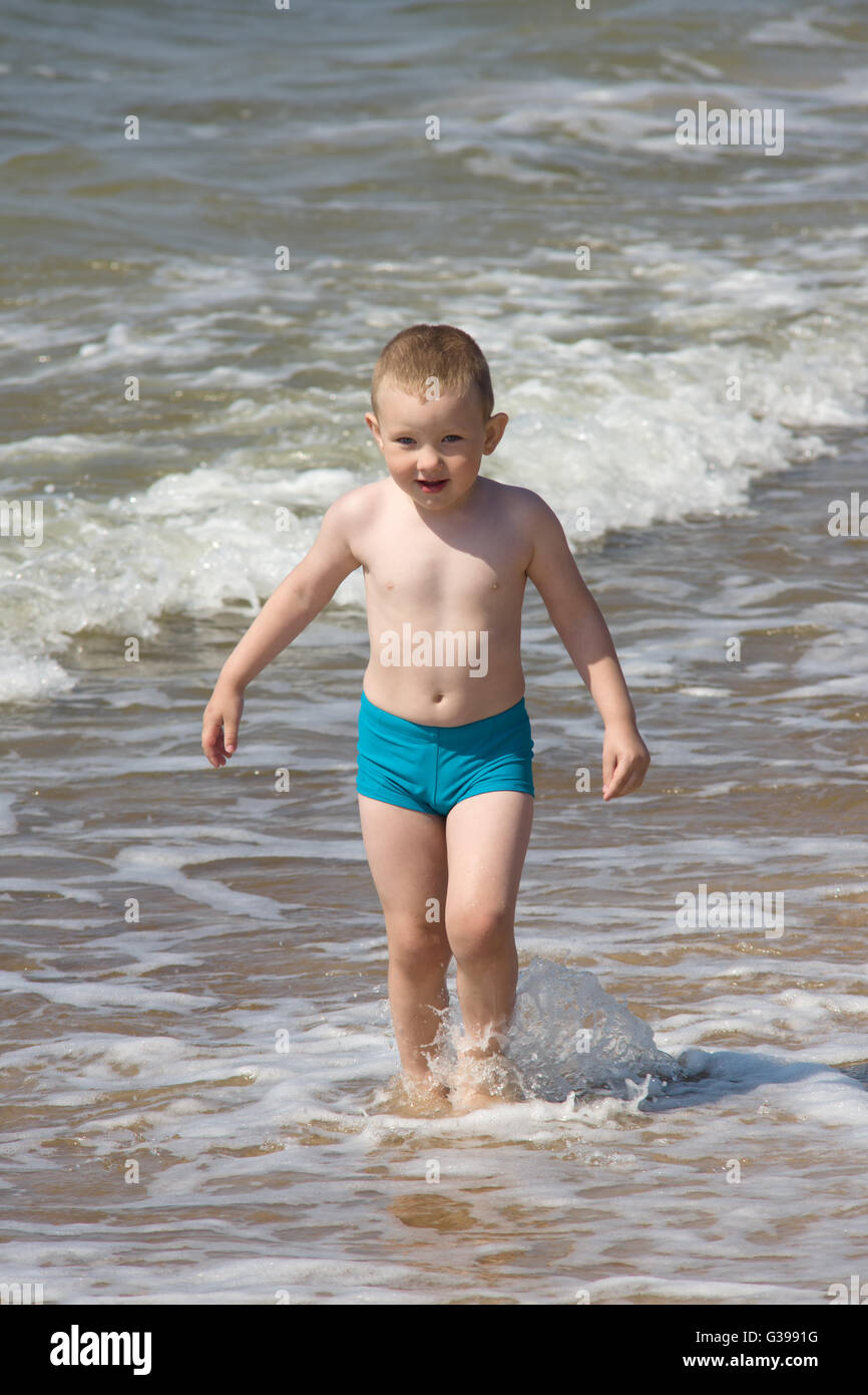 little boy in swim trunks