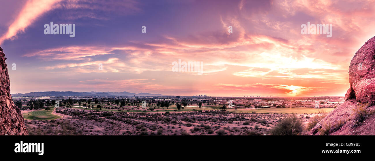 Panorama of sunset over late evening red sky over Phoenix,Arizona.  Papago Park buttes in foreground. Stock Photo
