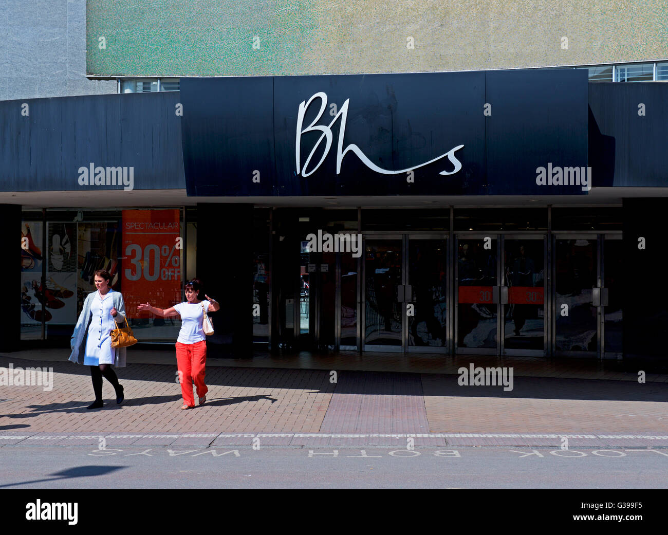 Two women and branch of BHS department store, Kingston upon Hull, East