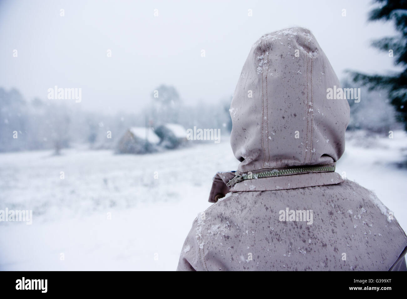 Boy looks out over a wintry landscape Dordogne France Stock Photo
