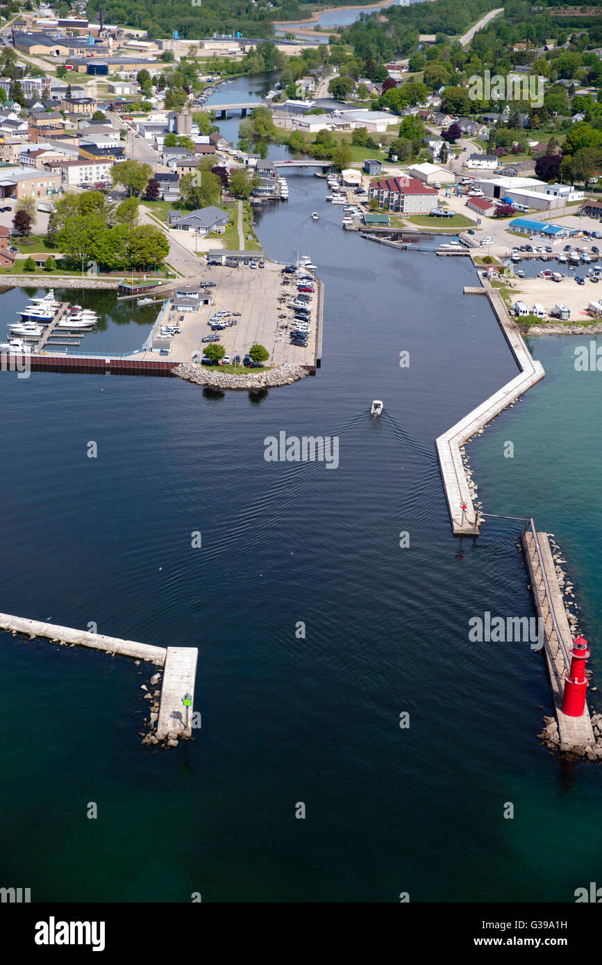 High-angle, aerial view of the Algoma Lighthouse, Algoma, Wisconsin, with a boat entering the harbor. Stock Photo