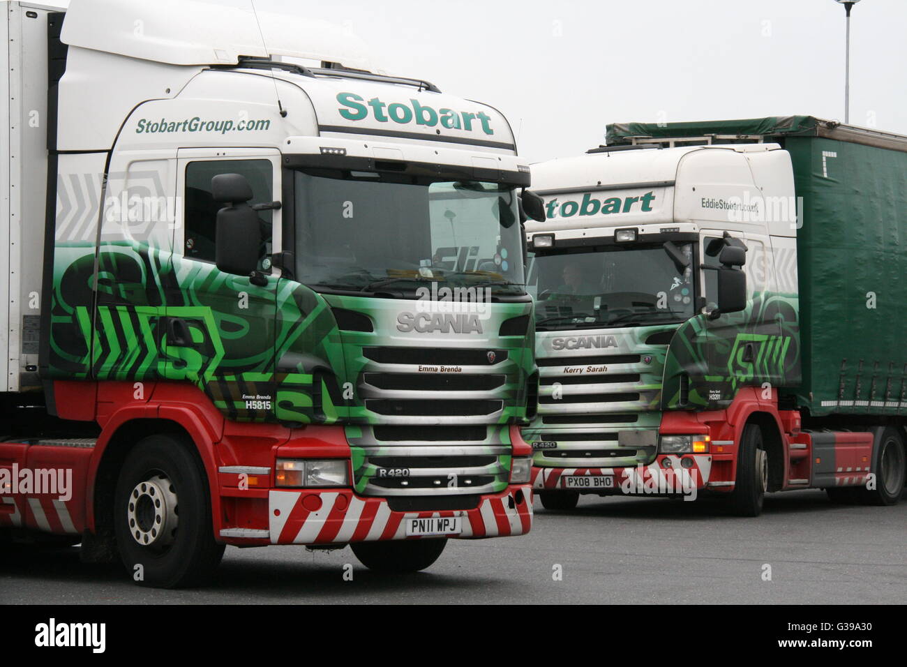 A PAIR OF EDDIE STOBART SCANIA TRUCKS AT A MOTORWAY SERVICE AREA Stock Photo