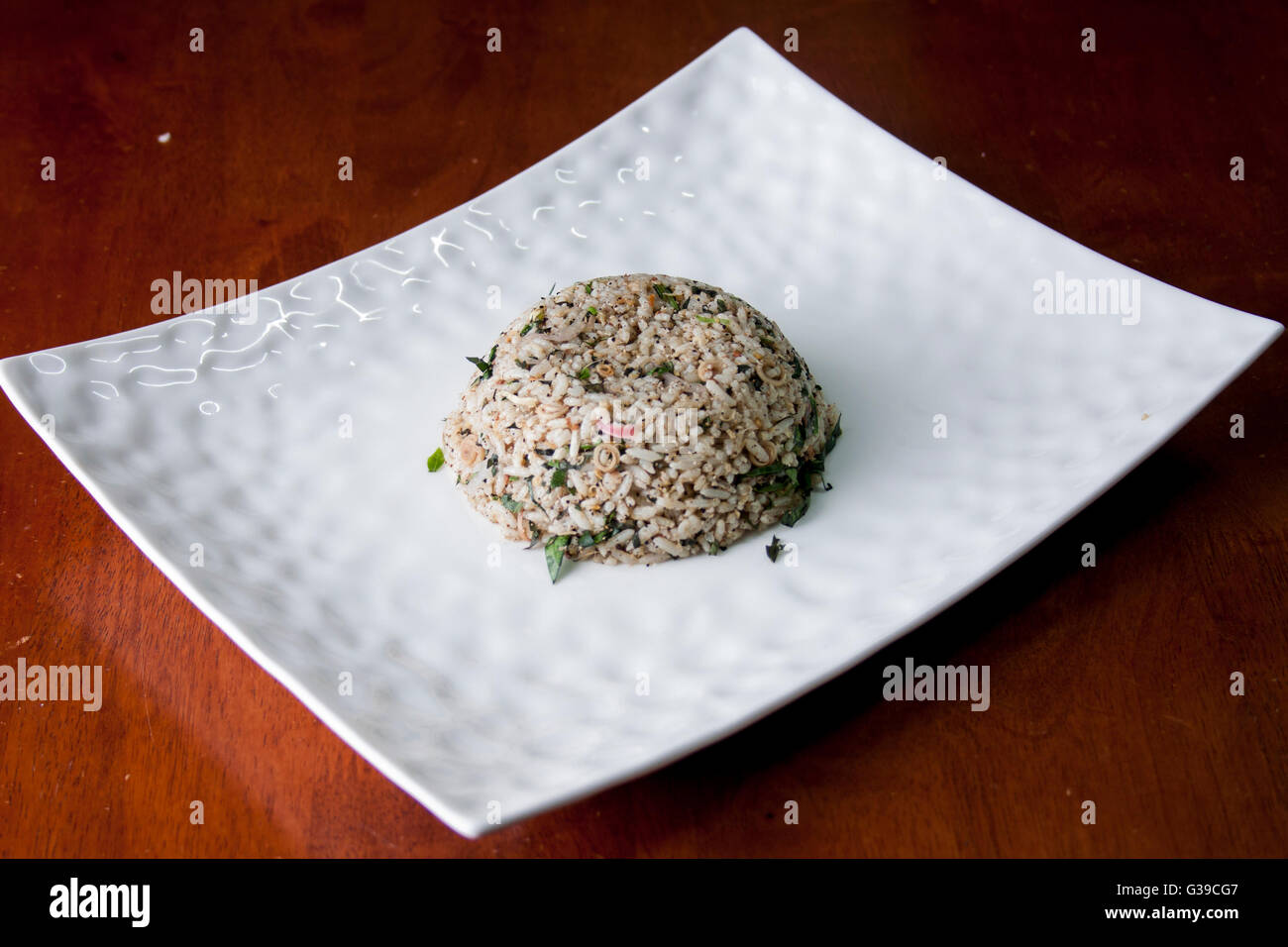 Nasi kerabu or herbed rice without condiments Stock Photo