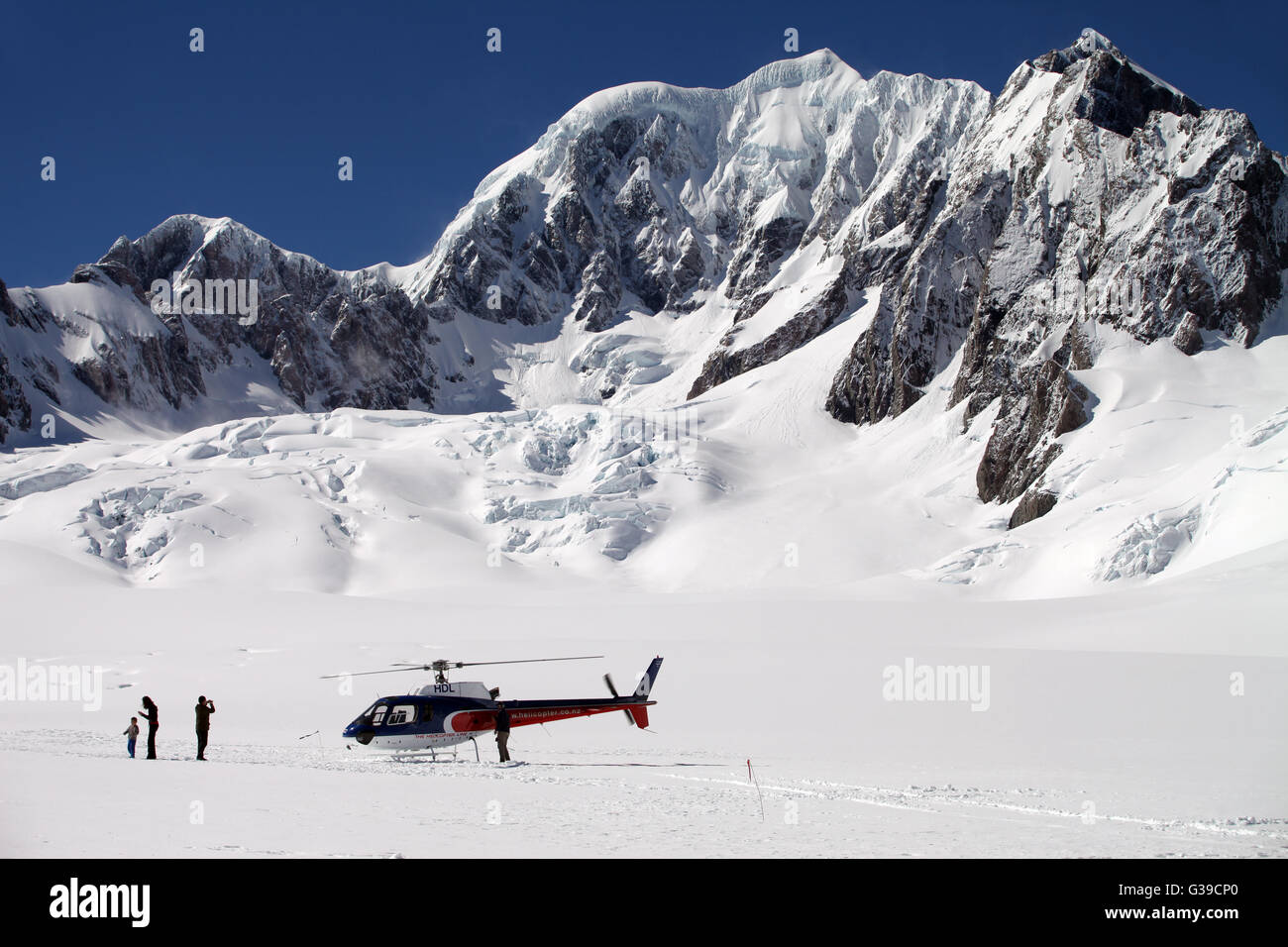 Helicopter with tourists on the top of Franz Josef Glacier, Southern Alps, New Zealand Stock Photo
