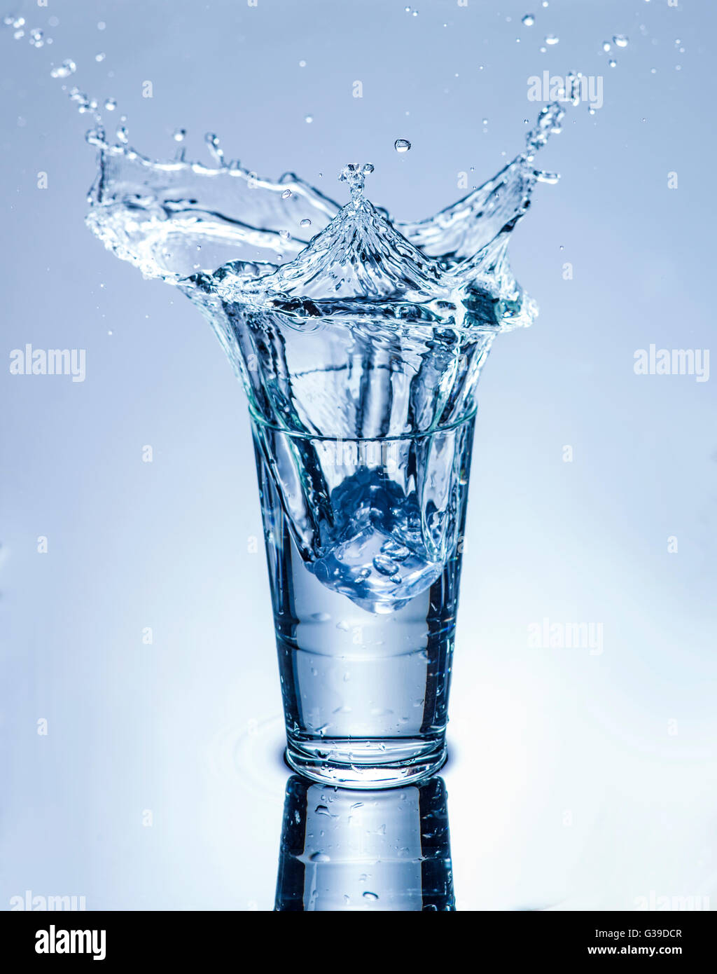 Glass of water. Glass of cold water with splash and dew drops