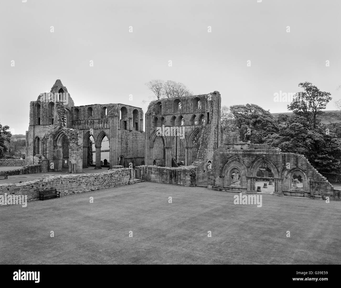 View ENE across cloister of Dundrennan Abbey, Kirkcudbright, to the C13th chapter-house entrance (R) & S & N transepts of C12th monastic church. Stock Photo